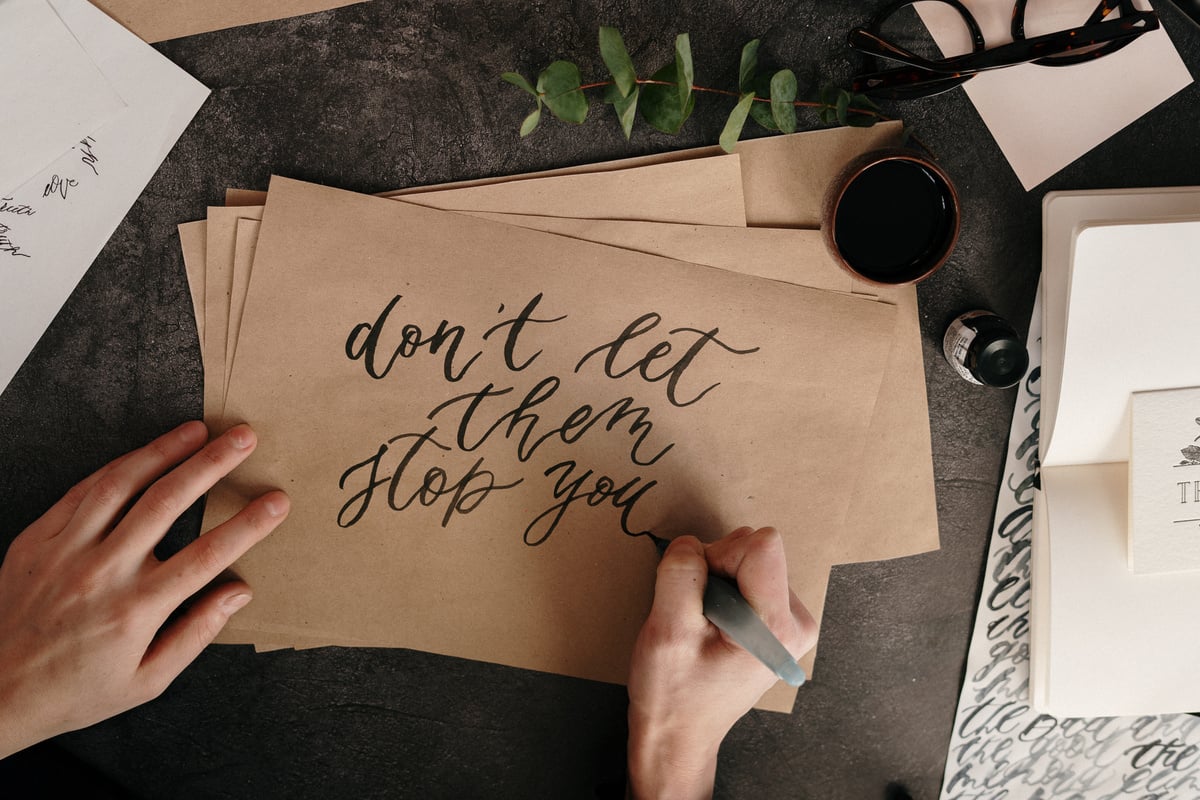 Person Writing on Brown Envelopes